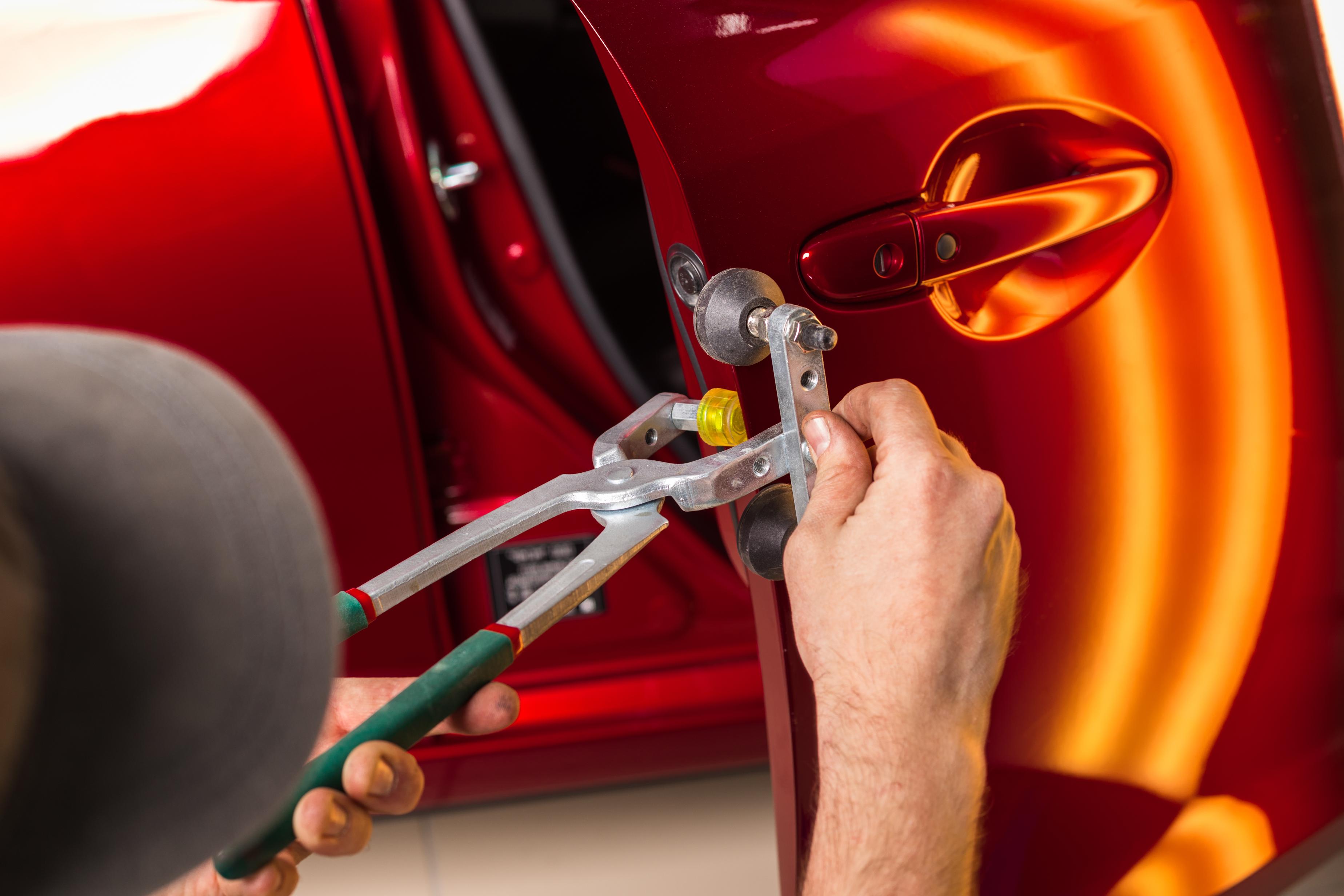 Paintless dent repair on a car panel near Fultonville, NY